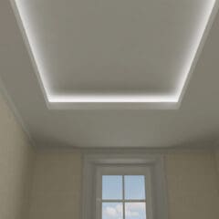 The room, crafted by a skilled dry lining contractor, features beige walls and a large rectangular recessed ceiling with ambient lighting. Below, a window showcases the blue sky with scattered clouds, flooding the space with natural light.